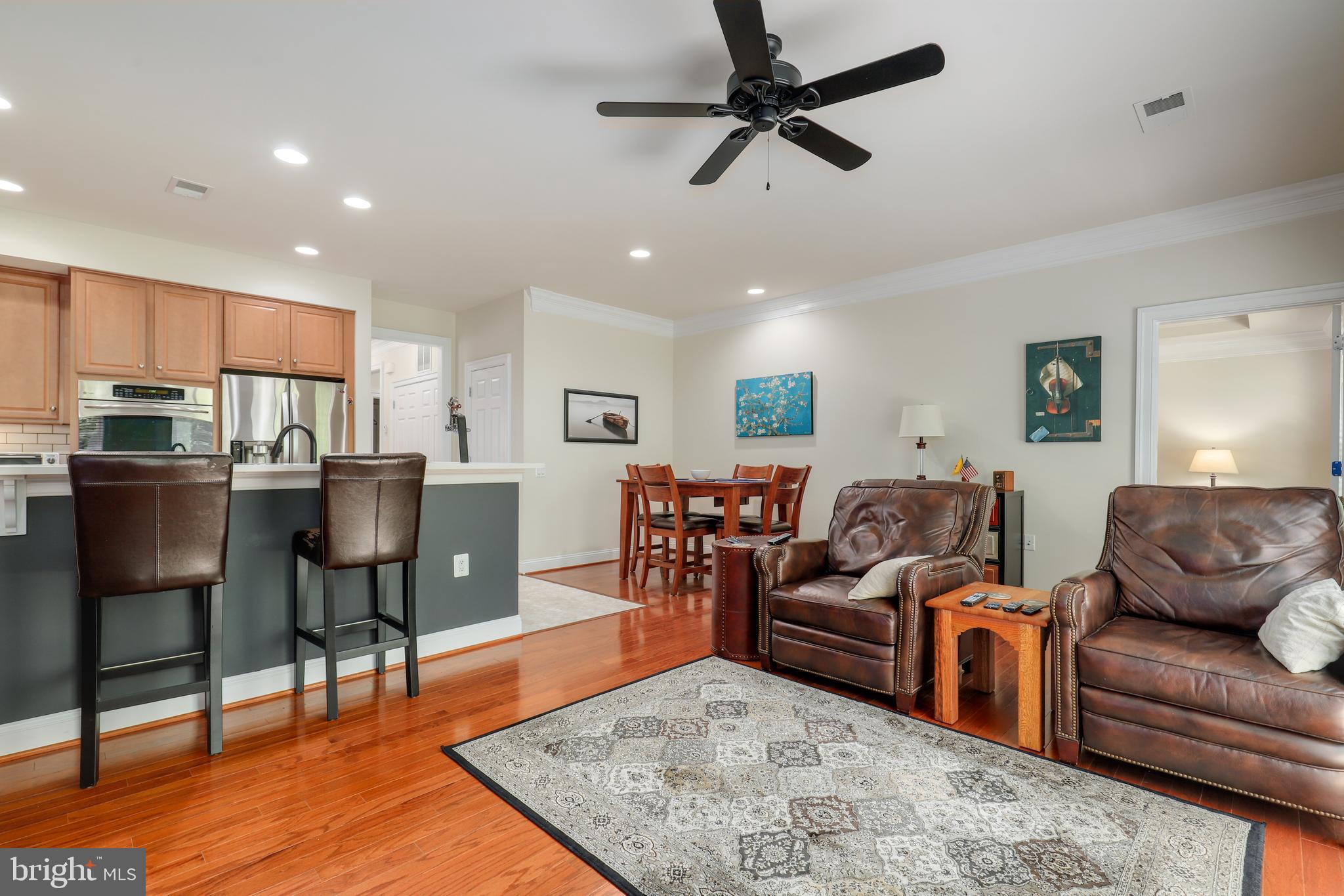 44268 Panther Ridge Drive Ashburn, VA 20147 - Photo 12 of 32 a living room kitchen with furniture and a wooden floor
