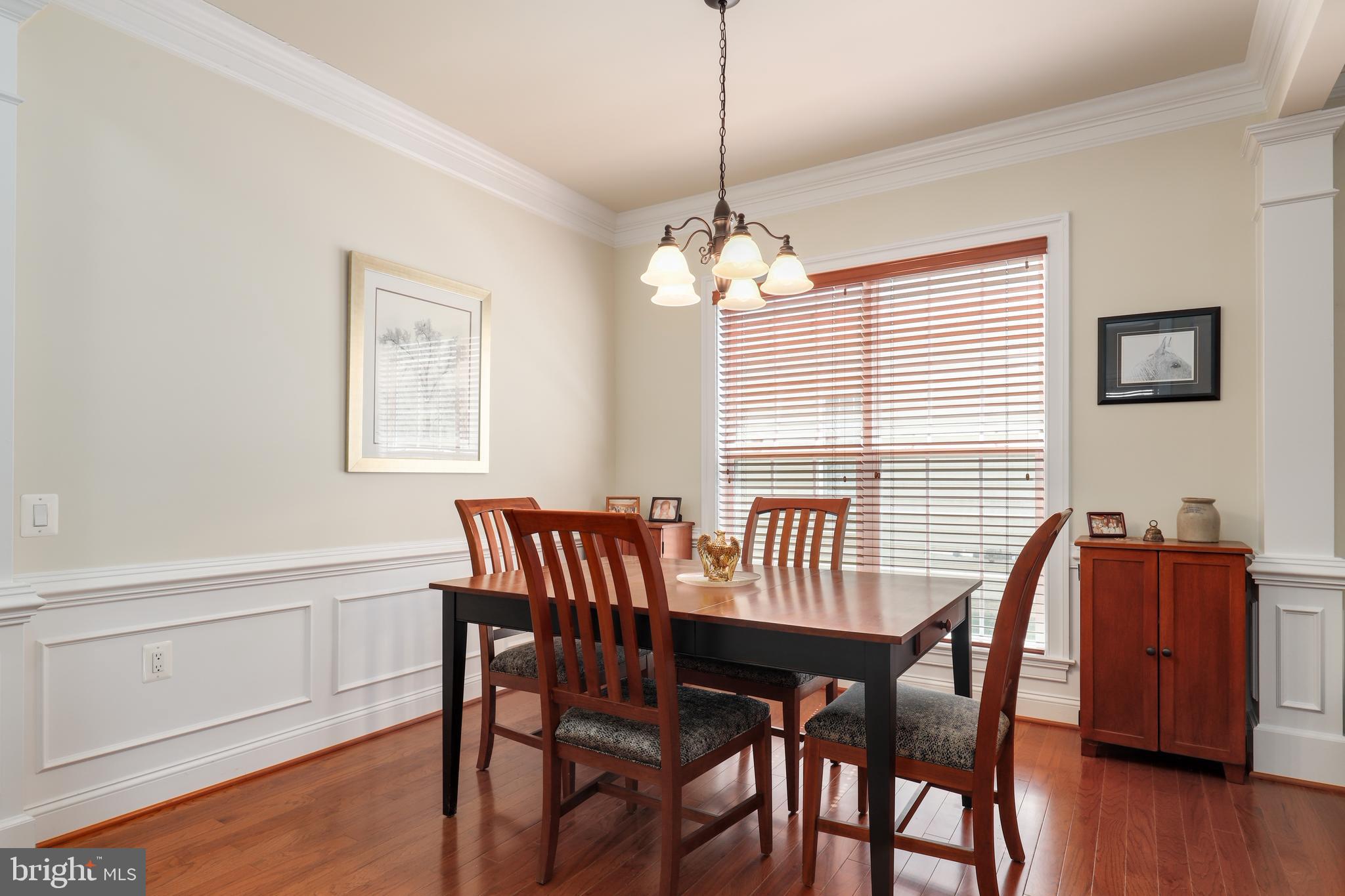 44268 Panther Ridge Drive Ashburn, VA 20147 - Photo 13 of 32 a view of a dining room with furniture window and wooden floor