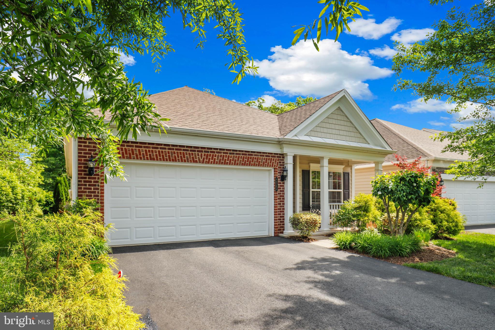 44268 Panther Ridge Drive Ashburn, VA 20147 - Photo 2 of 32 a front view of a house with a garden