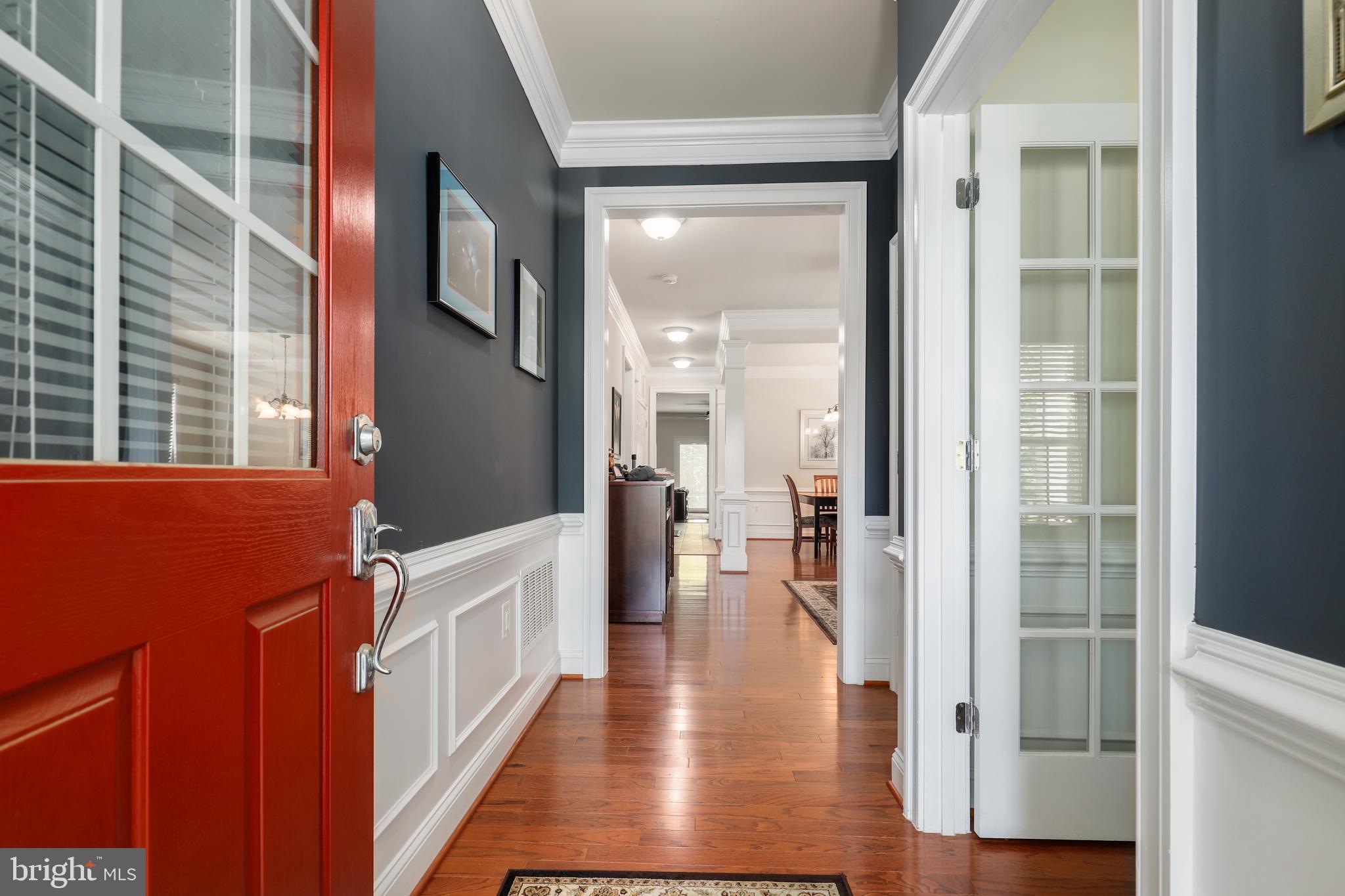 44268 Panther Ridge Drive Ashburn, VA 20147 - Photo 4 of 32 a view of a hallway with wooden floor and windows