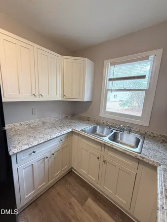 a kitchen with sink cabinets and window