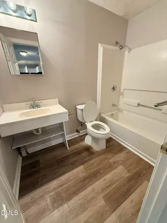 a bathroom with a sink a toilet a vanity and mirror