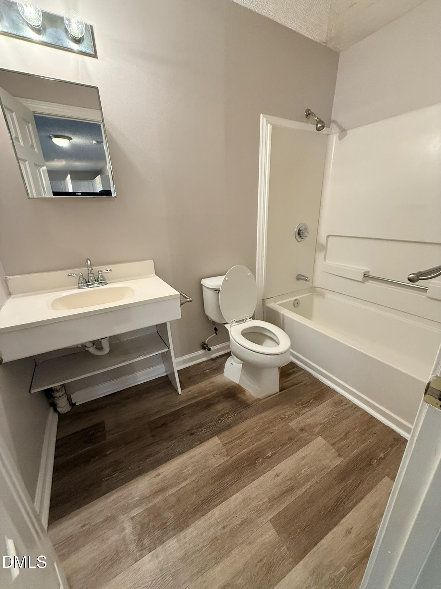 2120 Hawkins Street, Unit A Raleigh, NC 27610 - Photo 14 of 17 a bathroom with a sink a toilet a vanity and mirror