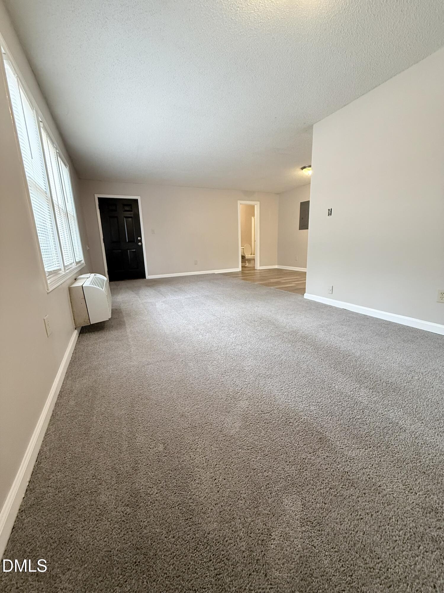 2120 Hawkins Street, Unit A Raleigh, NC 27610 - Photo 4 of 17 a view of a livingroom with an empty space and a window