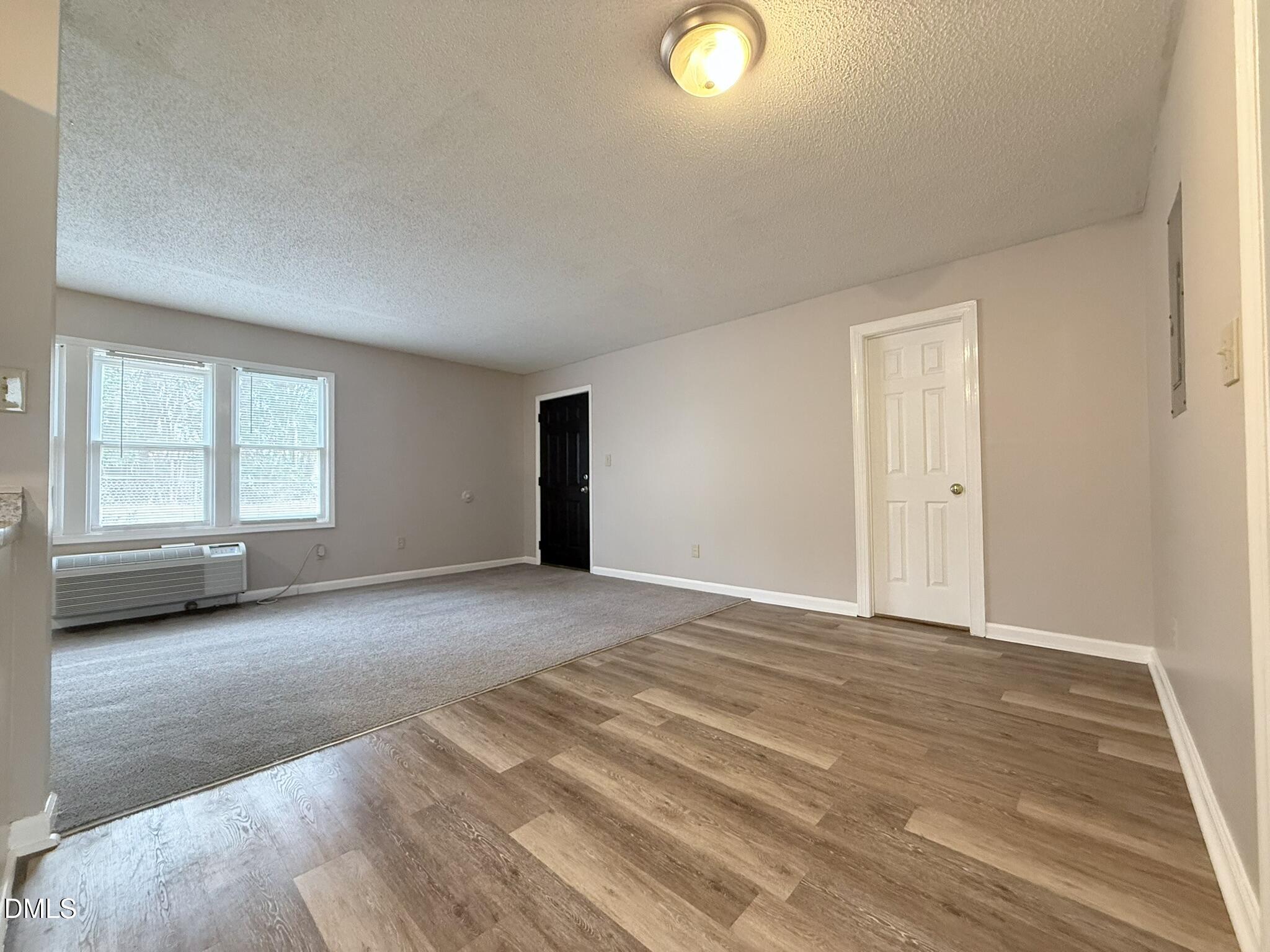2120 Hawkins Street, Unit A Raleigh, NC 27610 - Photo 6 of 17 a view of empty room with wooden floor and fan