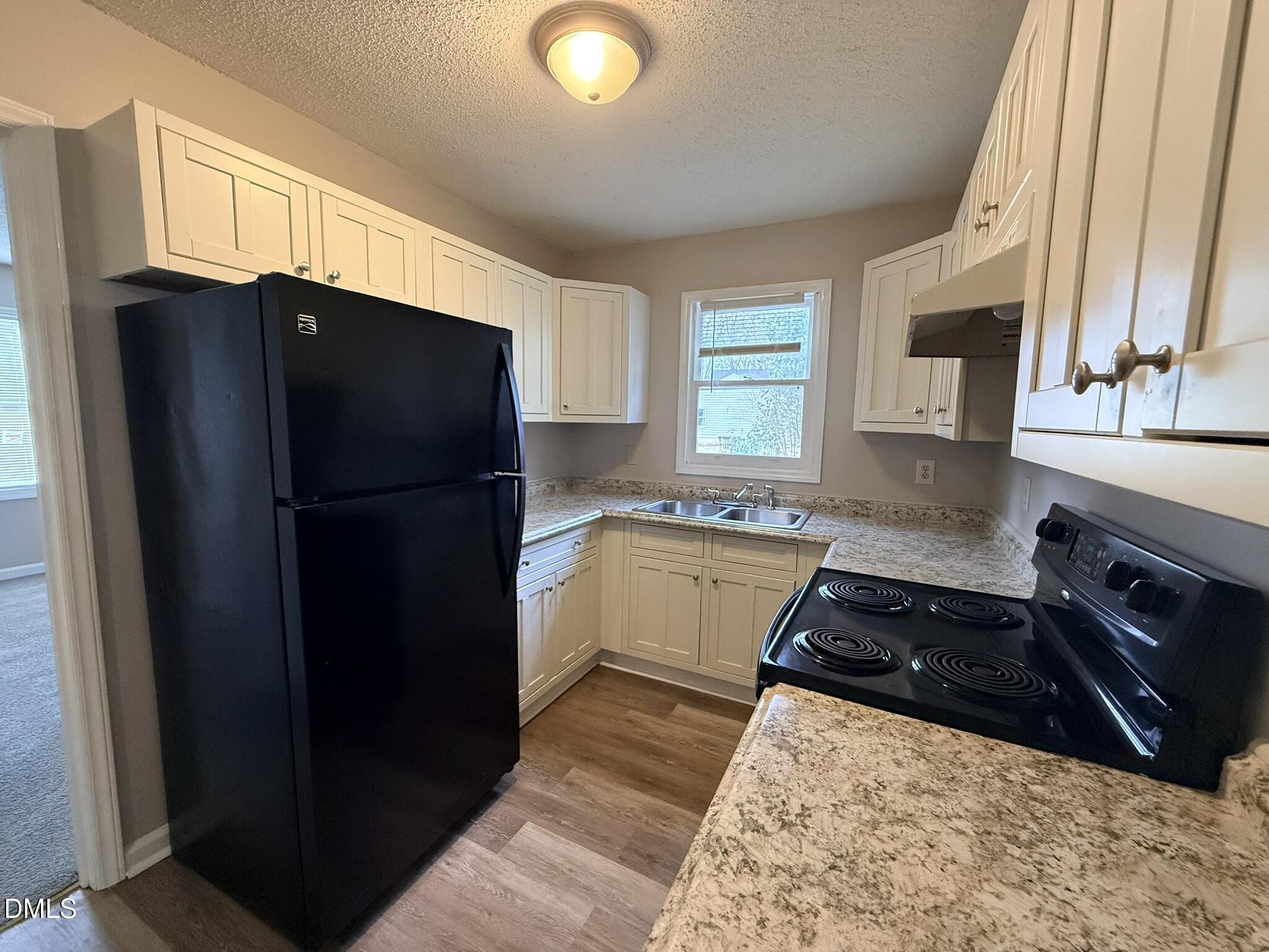2120 Hawkins Street, Unit A Raleigh, NC 27610 - Photo 8 of 17 a kitchen with a refrigerator and a sink