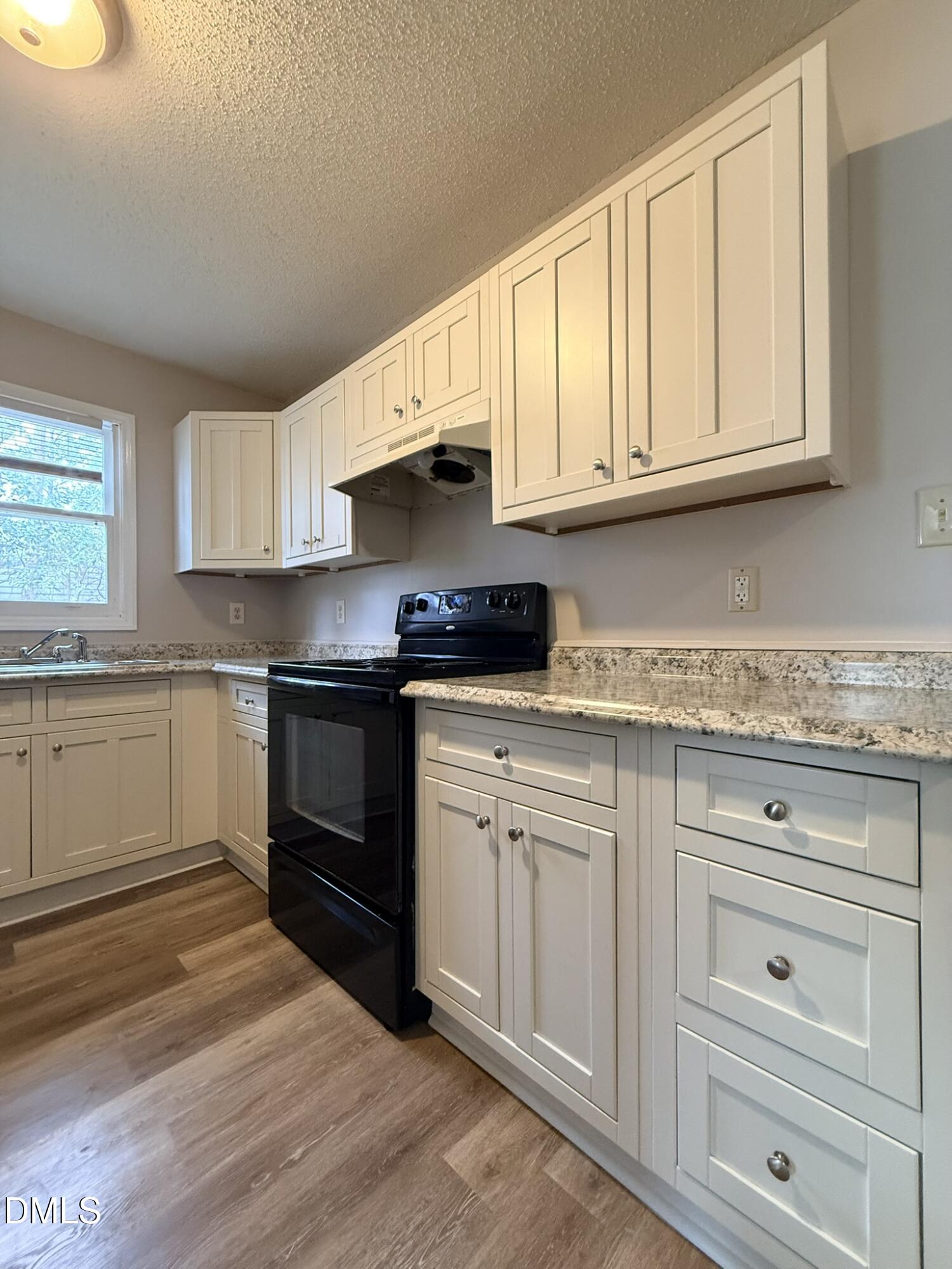 2120 Hawkins Street, Unit A Raleigh, NC 27610 - Photo 9 of 17 a kitchen with granite countertop white cabinets and white appliances