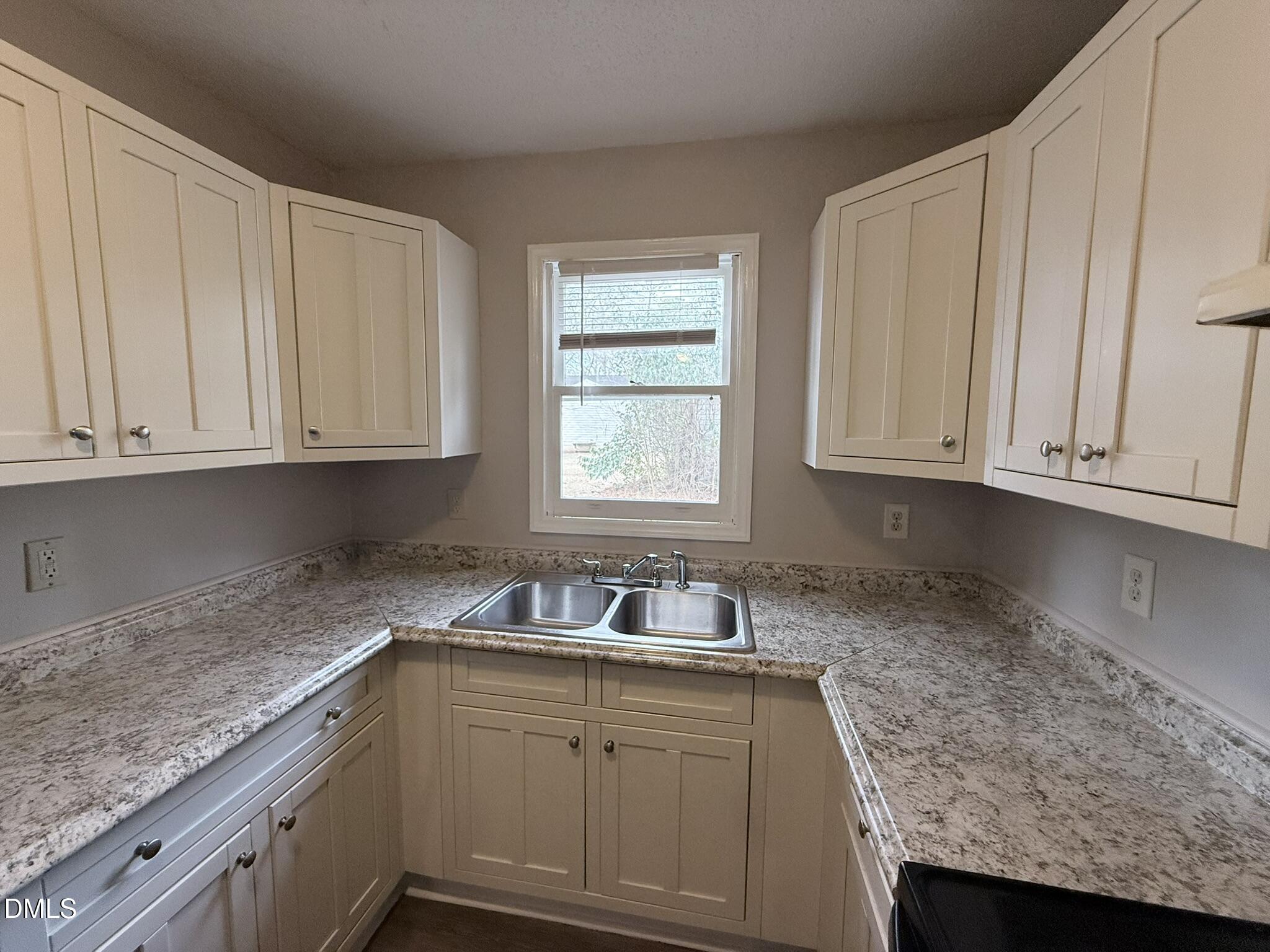 2120 Hawkins Street, Unit A Raleigh, NC 27610 - Photo 10 of 17 a kitchen with granite countertop white cabinets and sink