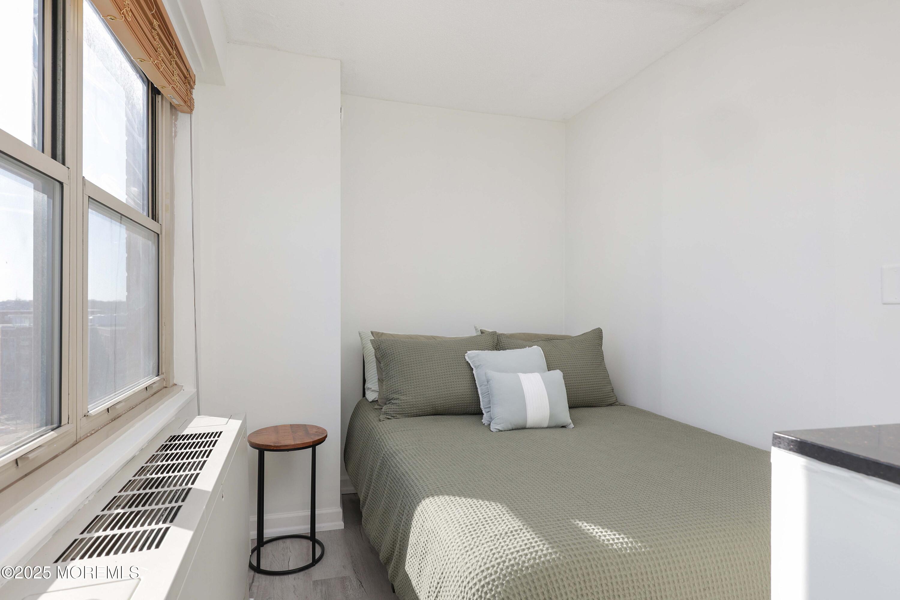 28 Riverside Avenue, Unit 7D Red Bank, NJ 07701 - Photo 14 of 28 a bedroom with a bed and a window