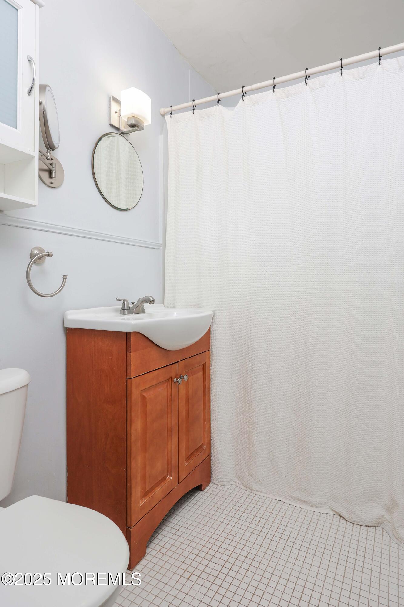 28 Riverside Avenue, Unit 7D Red Bank, NJ 07701 - Photo 15 of 28 a bathroom with a sink a toilet and mirror