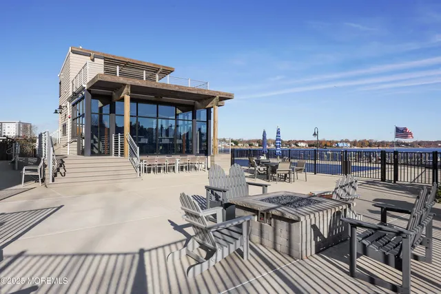a view of a roof deck with table and chairs