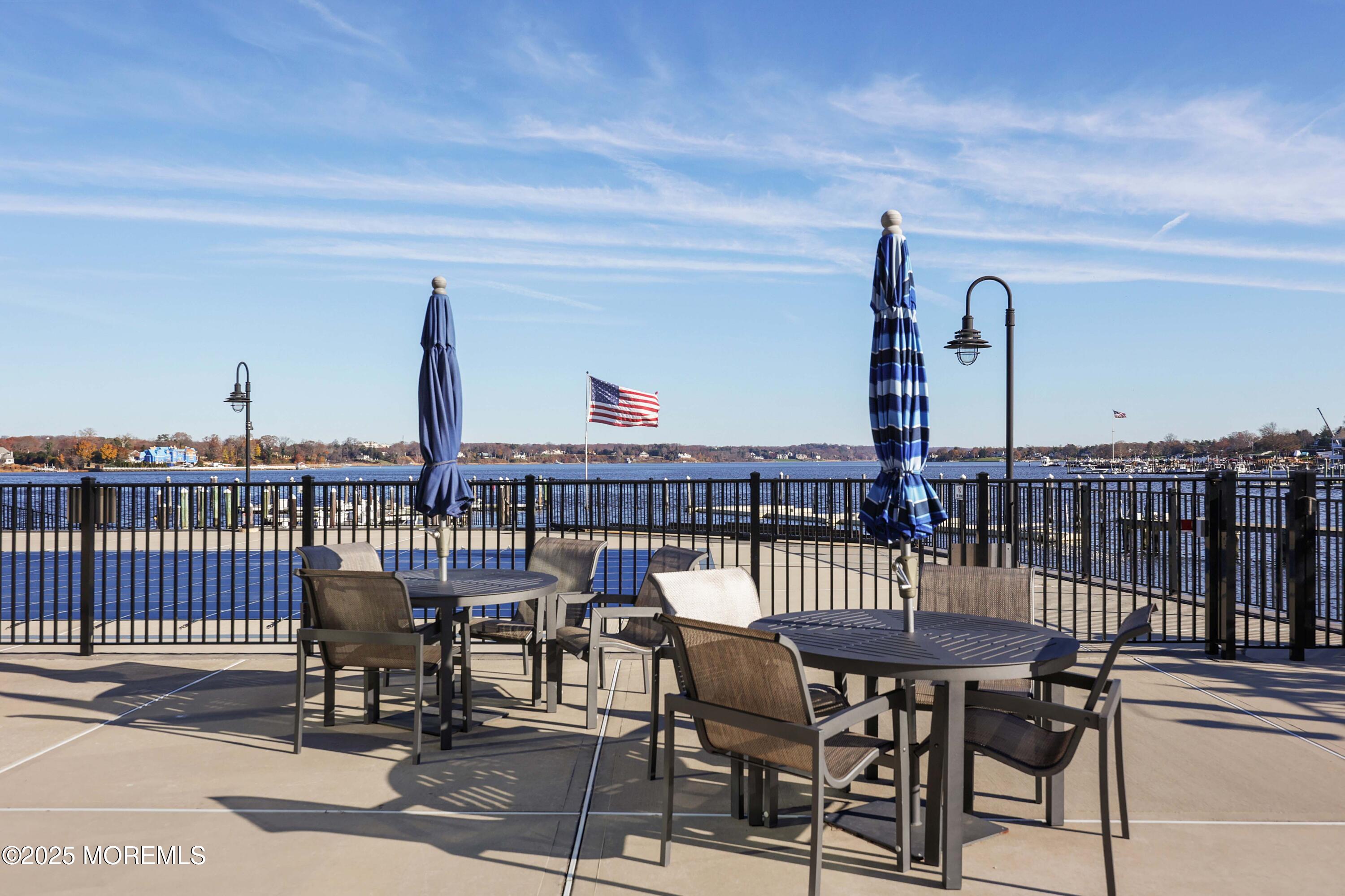 28 Riverside Avenue, Unit 7D Red Bank, NJ 07701 - Photo 20 of 28 a view of a roof deck with table and chairs