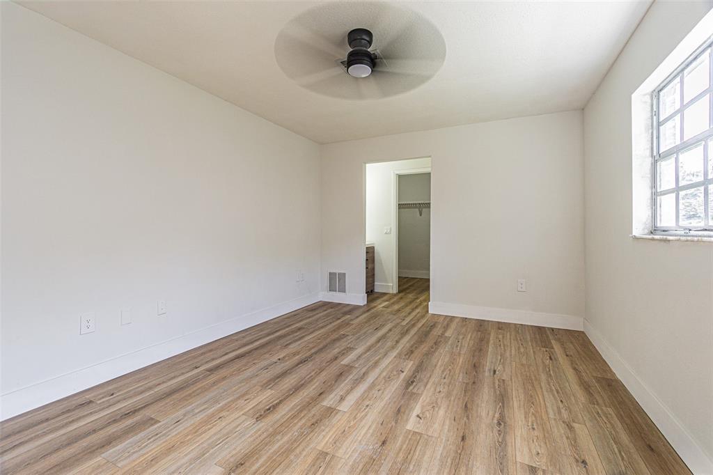 8405 Reynolds Drive Hudson, FL 34667 - Photo 13 of 30 a view of a room with wooden floor and a ceiling fan