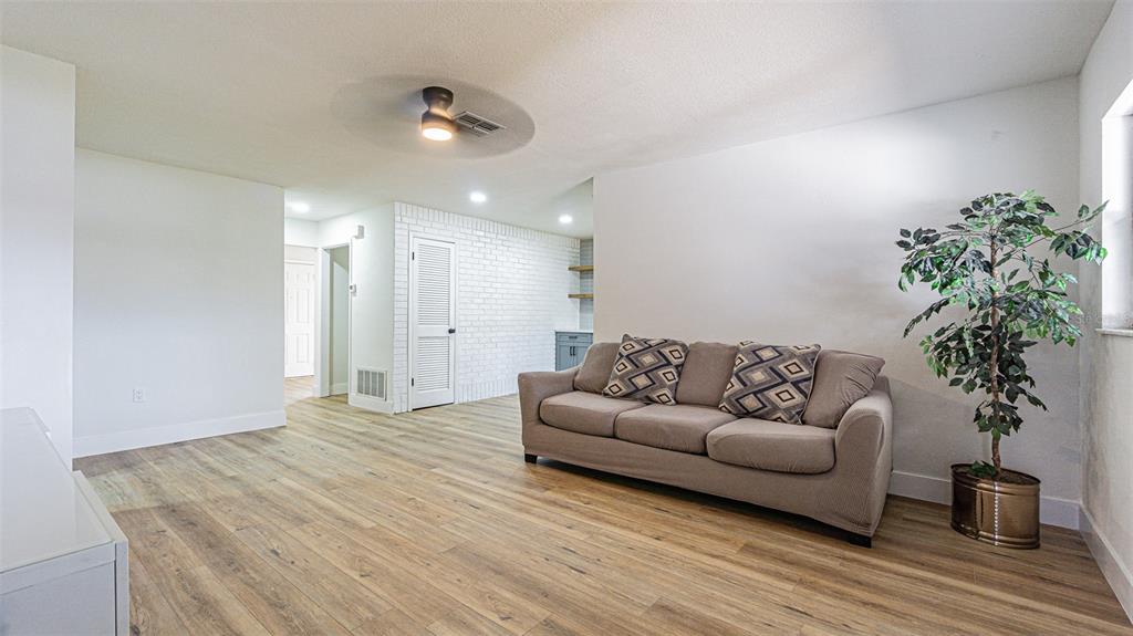 8405 Reynolds Drive Hudson, FL 34667 - Photo 17 of 30 a living room with furniture and a potted plant