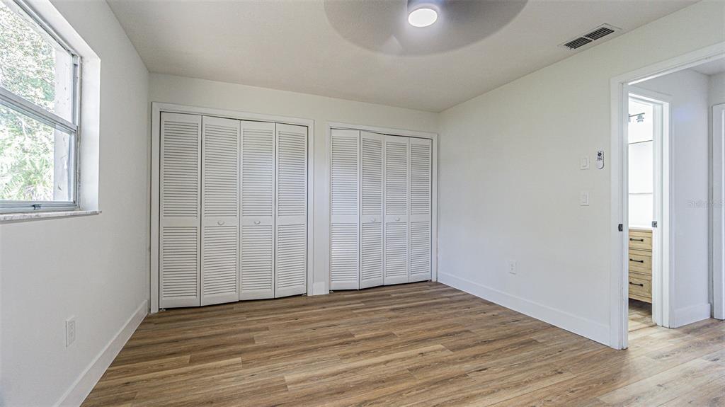 8405 Reynolds Drive Hudson, FL 34667 - Photo 20 of 30 an empty room with wooden floor and windows