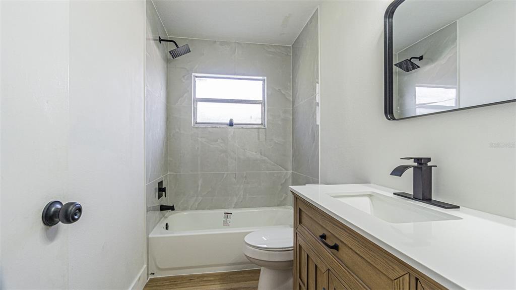 8405 Reynolds Drive Hudson, FL 34667 - Photo 22 of 30 a bathroom with a sink toilet and shower