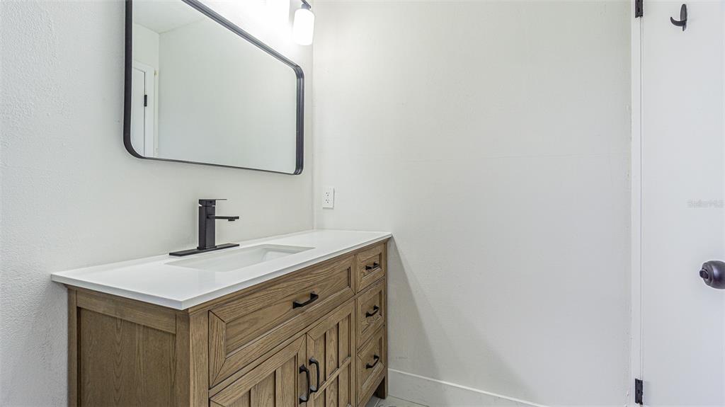 8405 Reynolds Drive Hudson, FL 34667 - Photo 23 of 30 a bathroom with a sink and a mirror