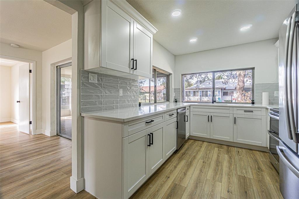 8405 Reynolds Drive Hudson, FL 34667 - Photo 8 of 30 a kitchen with sink cabinets and wooden floor
