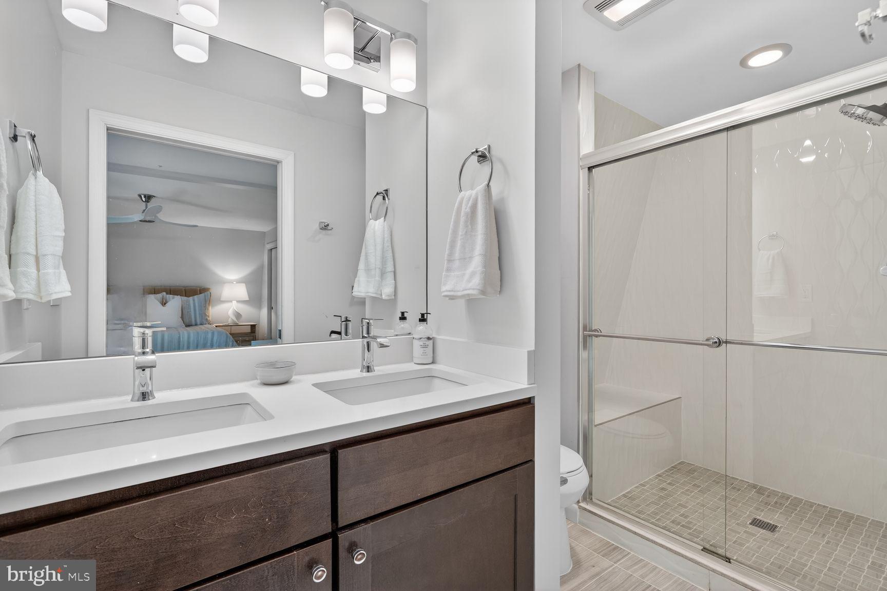 11201 Wedge Drive Reston, VA 20190 - Photo 19 of 31 a bathroom with a double vanity sink mirror and shower