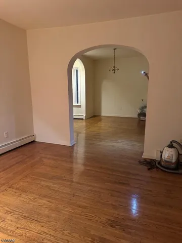 a view of a room with wooden floor