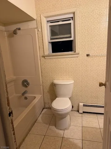 a bathroom with a toilet a sink and bathtub