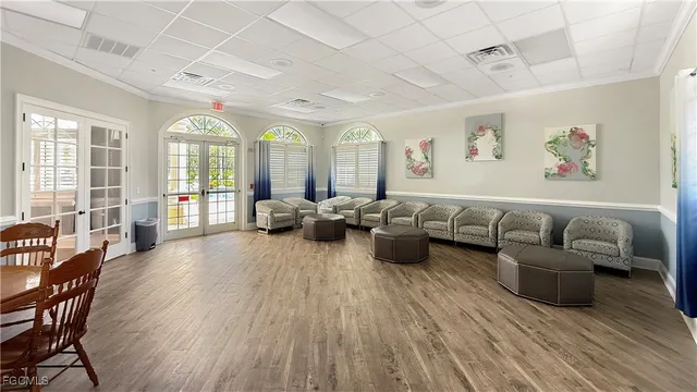 a kitchen with stainless steel appliances granite countertop a refrigerator a sink and dishwasher with wooden floor