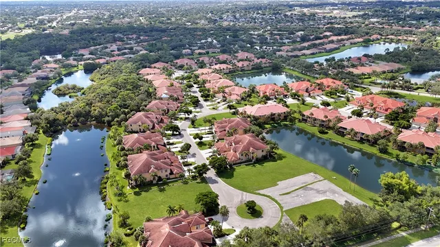 an aerial view of a house with a yard lake view and mountain view