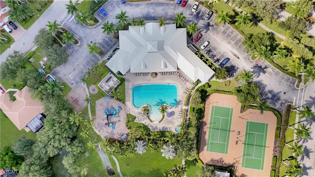 an aerial view of a house with a yard basket ball court and outdoor seating