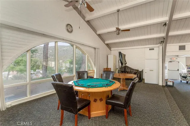 a dining room with furniture a rug and a large window