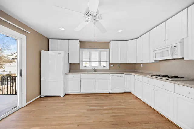 a kitchen with a refrigerator and a stove top oven