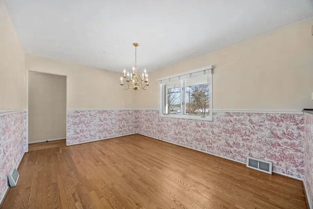 a living room with furniture fireplace and a large window