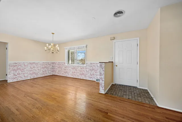 a big room with wooden floor and windows