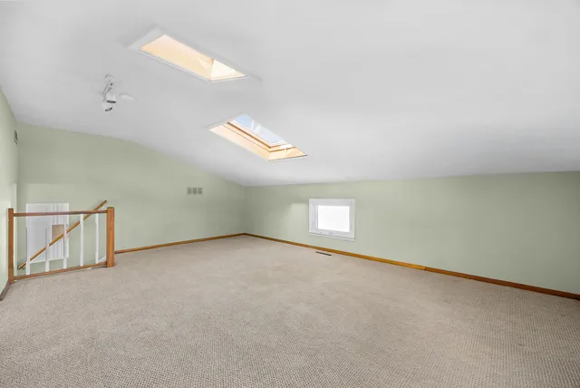 a living room with furniture and large windows