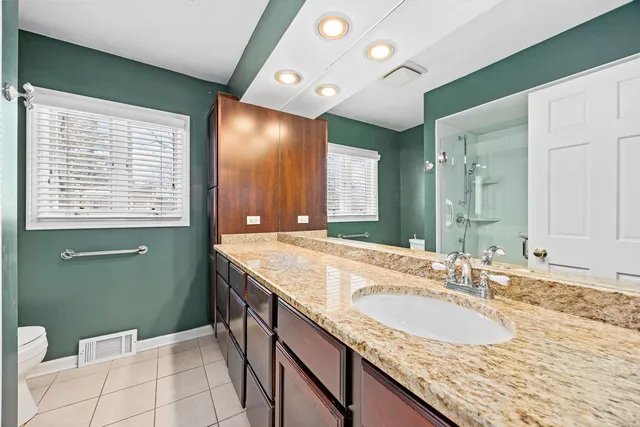 a spacious bedroom with a bed and a dresser