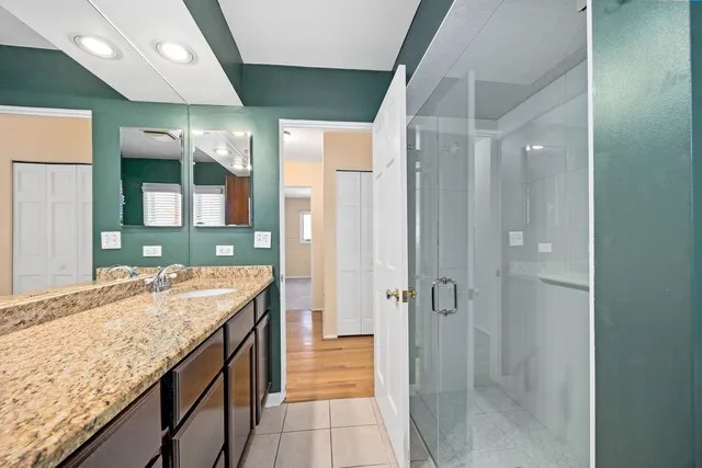 an empty room with windows and ceiling fan