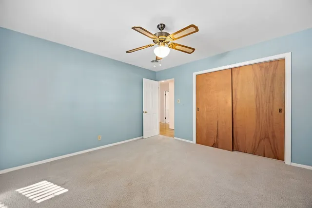 wooden floor in an empty room with a bathroom