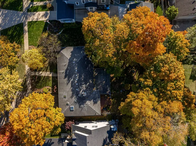 a view of a dining room and livingroom with furniture wooden floor a chandelier