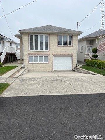 159-15 80th Street Queens, NY 11414 - Photo 1 of 13 a front view of a house with a yard and garage