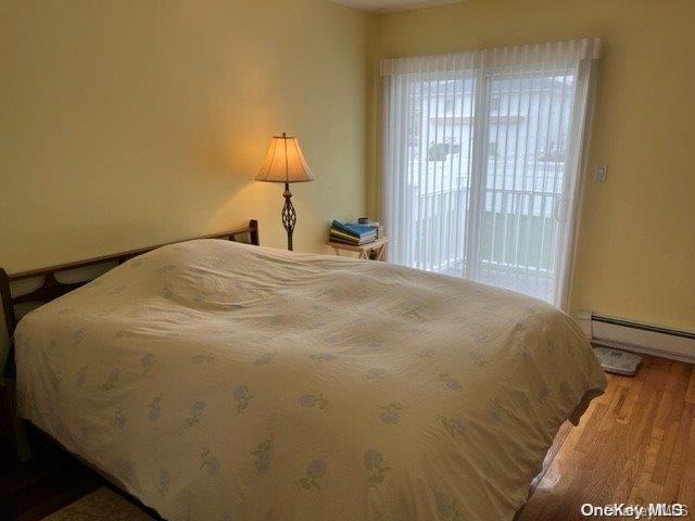 159-15 80th Street Queens, NY 11414 - Photo 12 of 13 a large bed sitting in a bedroom next to a window