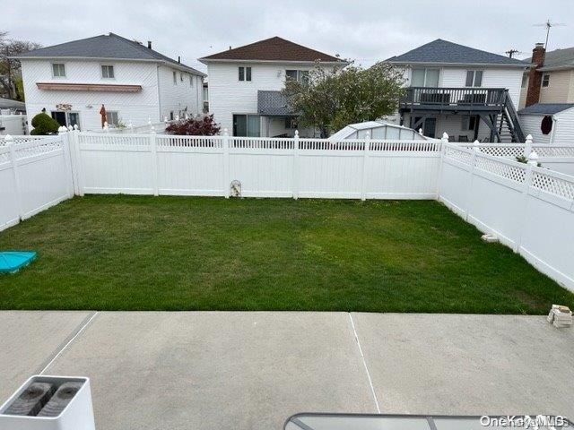 159-15 80th Street Queens, NY 11414 - Photo 13 of 13 a view of a white house and a yard with a bench