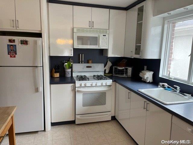 159-15 80th Street Queens, NY 11414 - Photo 3 of 13 a kitchen with appliances a sink and cabinets
