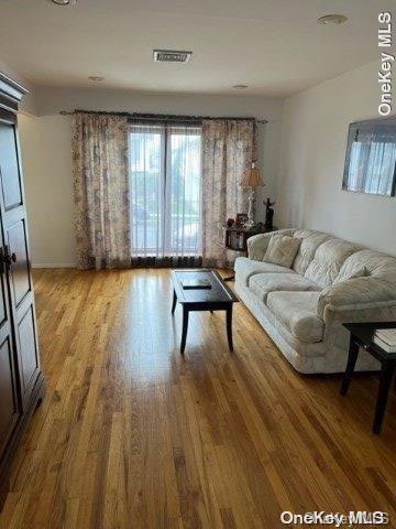 159-15 80th Street Queens, NY 11414 - Photo 6 of 13 a living room with furniture and a wooden floor