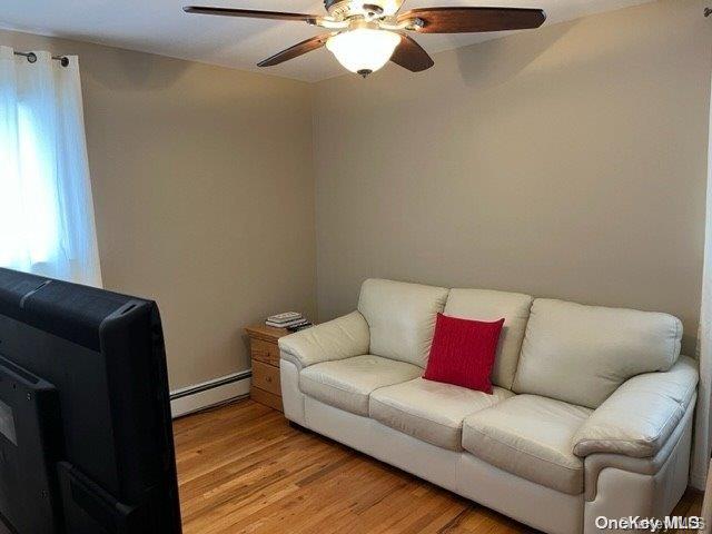 159-15 80th Street Queens, NY 11414 - Photo 9 of 13 a living room with furniture and a lamp