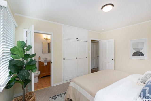 1446 North Harding Avenue Pasadena, CA 91104 - Photo 14 of 26 a bedroom with a bed and a potted plant