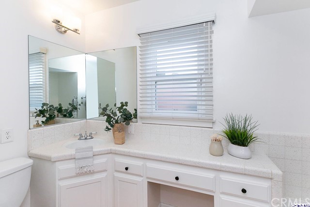 1446 North Harding Avenue Pasadena, CA 91104 - Photo 17 of 26 a bathroom with a potted plant on the counter and a wooden floor