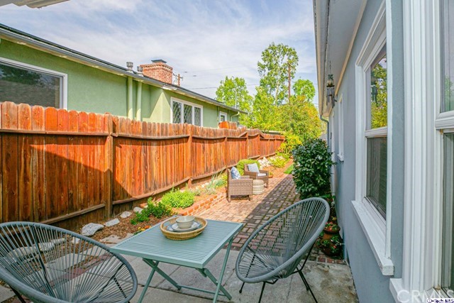 1446 North Harding Avenue Pasadena, CA 91104 - Photo 19 of 26 a backyard of a house with dining table and chairs with wooden floor
