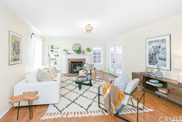 1446 North Harding Avenue Pasadena, CA 91104 - Photo 2 of 26 a living room with furniture a fireplace and a table