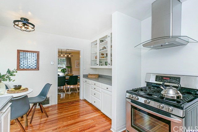 1446 North Harding Avenue Pasadena, CA 91104 - Photo 9 of 26 a kitchen with stainless steel appliances a stove a table and chairs