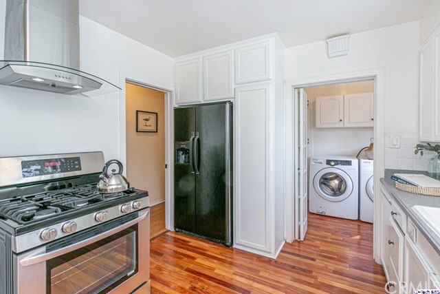 1446 North Harding Avenue Pasadena, CA 91104 - Photo 10 of 26 a kitchen with stainless steel appliances granite countertop a stove and a refrigerator