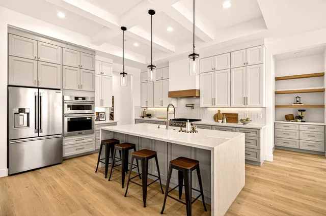 a view of a dining room with furniture and a chandelier